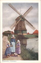 Watermolen with three girls in traditional dress, Volendam Postcard