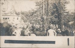 Crowd gathered in front of decorated building with trees Postcard
