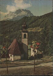 Alpine Church and Bell Tower beneath Snow-capped Mountain Postcard