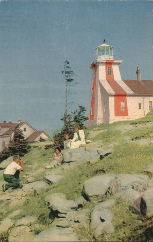 Point Prim Light, Digby, NS, family on rocky hill Canada