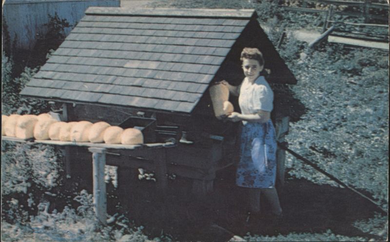 Woman with Bread from Open Oven, Gaspé Peninsula, Canada Rivière aux Renards QC