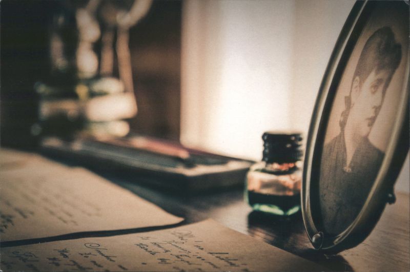 Nostalgic Desk Scene with Letters, Inkwell, Woman's Portrait