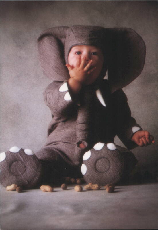 Baby in Elephant Costume with Peanuts, Hand to Mouth