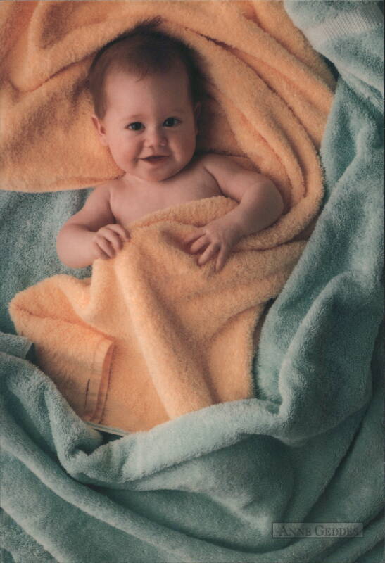 Smiling Baby Wrapped in Orange & Blue Blankets by Anne Geddes