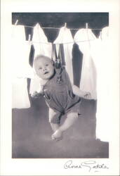 Baby in Overalls Hanging from Clothesline by Anne Geddes Postcard