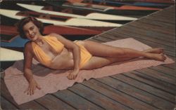 Smiling Woman in Yellow Swimsuit on Dock with Boats Postcard