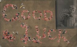 Good Luck message formed by pink flowers with bees and a young boy's portrait Postcard