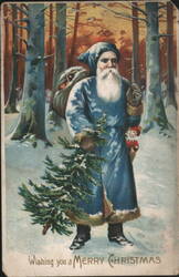 Santa Claus in Blue Robe with Christmas Tree in Snowy Forest Postcard