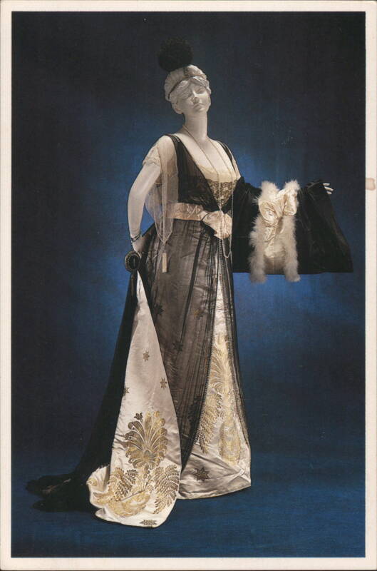 EVENING DRESS, circa 1913. Black chiffon, gilt-patterned white satin