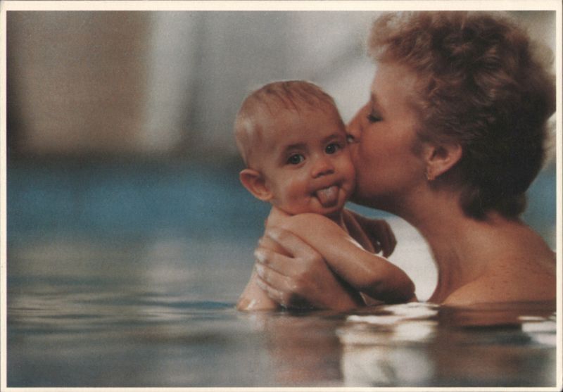 Nanny at work: Woman Kisses Baby in Water, Baby Sticks Tongue