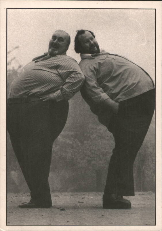 Two Smiling Large Men Leaning Back-to-Back Fat People