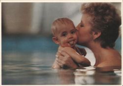 Nanny at work: Woman Kisses Baby in Water, Baby Sticks Tongue Postcard