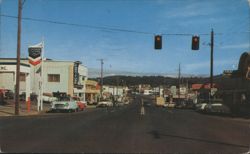 Main Street with Businesses and Traffic Lights Postcard