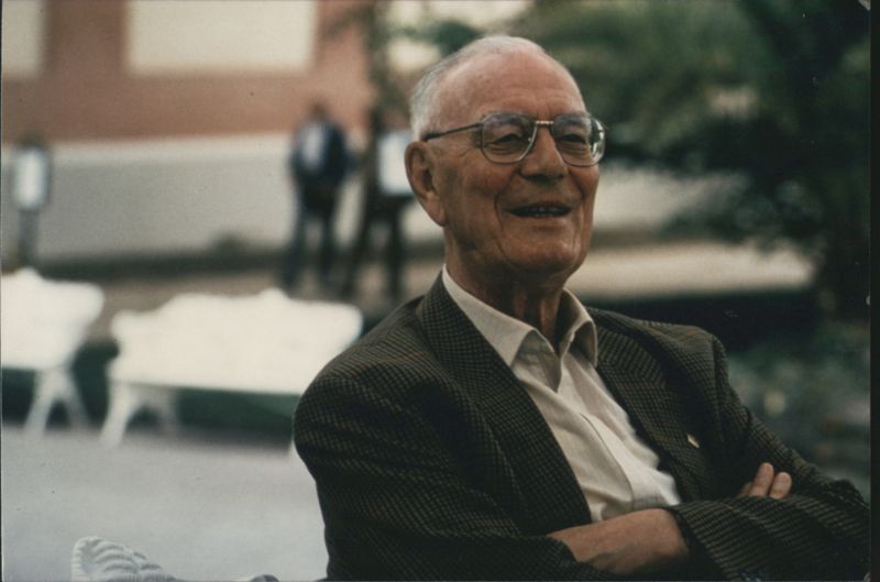 Elderly Man with Glasses Smiling, Checkered Jacket