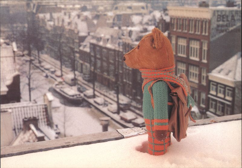Teddy Bear on Snowy Rooftop Overlooking Amsterdam Canal Netherlands