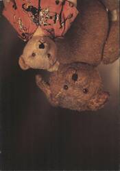 Two upside-down teddy bears, one wearing a patterned shirt Postcard