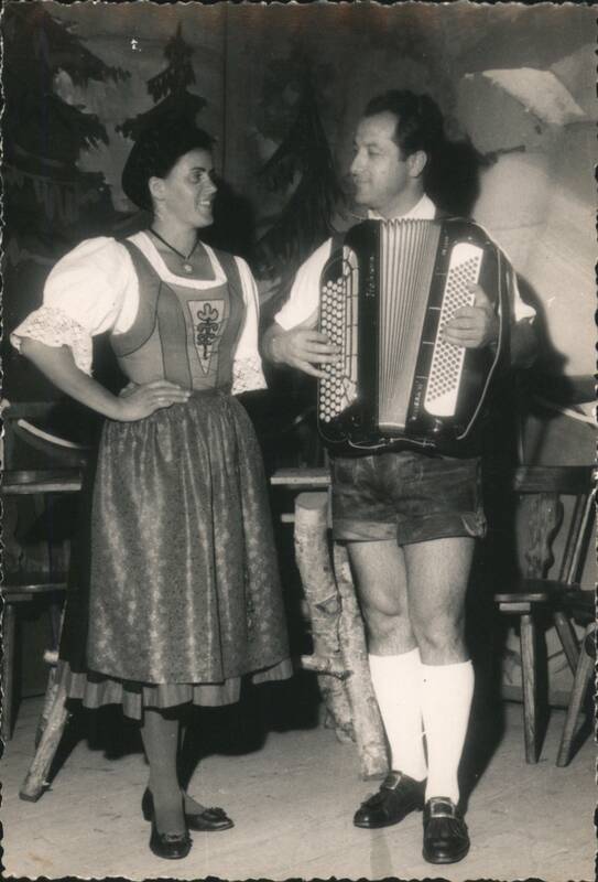 Man and Woman in Traditional Attire with Accordion