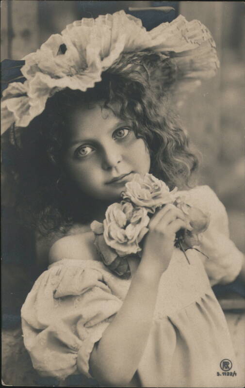 Girl with Curly Hair in Large Floral Hat Holding Roses