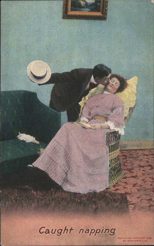 Caught Napping Man Kissing Sleeping Woman in Wicker Chair