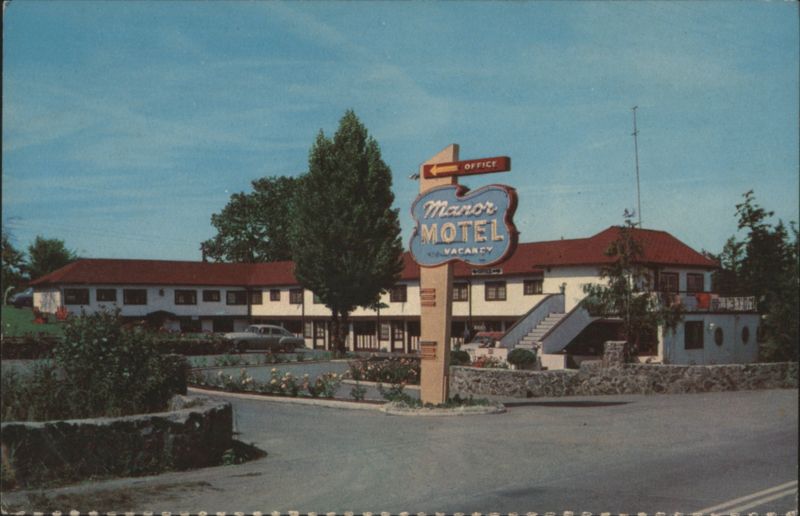 Manor Motel with Neon Sign and Landscaping Hotels