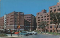 St. John's Hospital with Mid-Century Cars and Statue Postcard