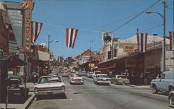 Main Street Scene with The Sportsman and Rexall Drugs Postcard
