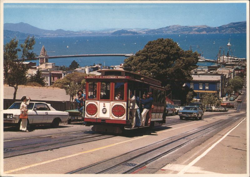 Cable Car Climbing Steep Hill with San Francisco Bay View California