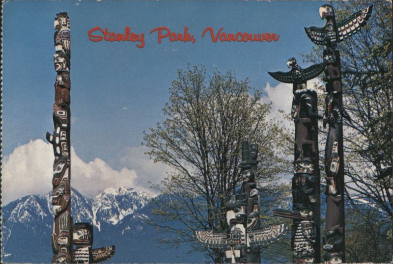 Totem Poles in Stanley Park with Mountain View Vancouver BC Canada