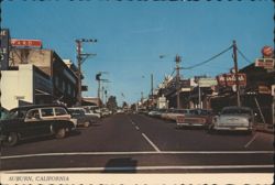 Street Scene with Vintage Cars and Local Businesses Postcard