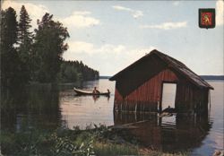 Red Boathouse and Rowboat on a Finnish Lake Postcard