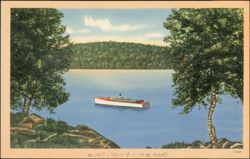 Man in Rowboat on Lake with Forested Hills Postcard