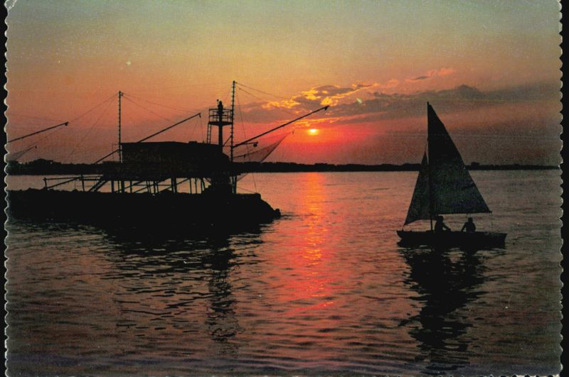 Sunset over Fishing Pier and Sailboat Sailboats