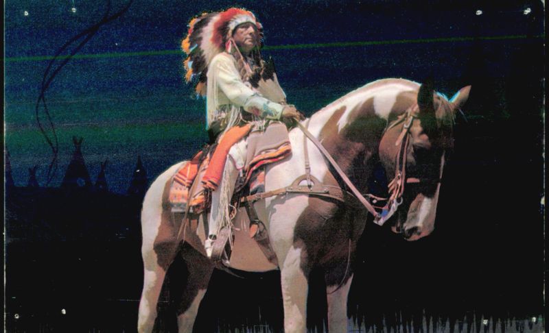 Native American Chief in Full Headdress on Pinto Horse