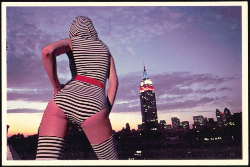 Woman in Striped Outfit with Empire State Building Skyline New York