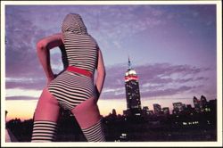 Woman in Striped Outfit with Empire State Building Skyline Postcard