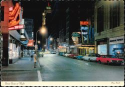 Street Scene at Night with Neon Signs Postcard