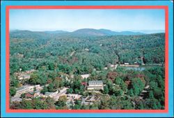 Aerial view of town and mountains Postcard