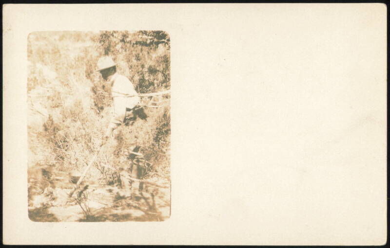 Person in hat walking through dense woods Unidentified People
