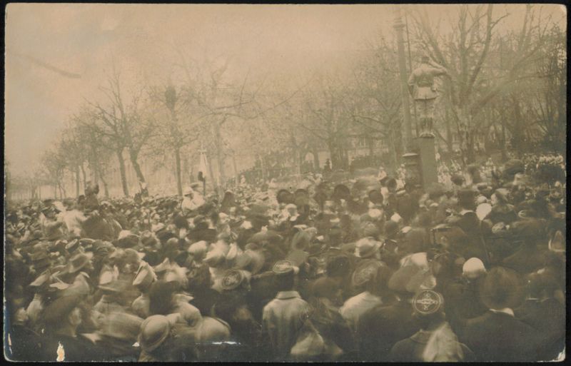 Crowd Gathered Around Statue of Man Saluting Unidentified People