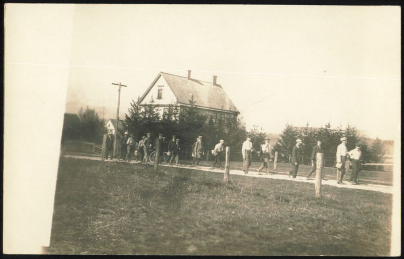 Group of Men Walking Down a Dirt Road