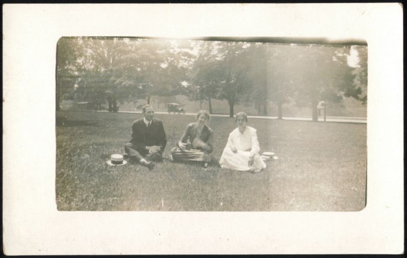 Man & Two Women Picnicking in Park Unidentified People