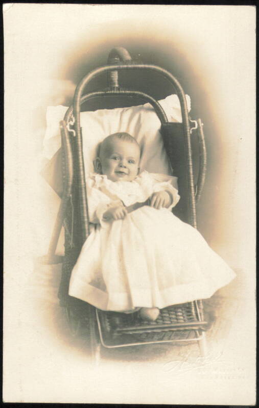 Smiling Baby in Wicker Bassinet Babies