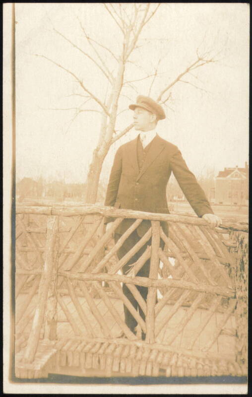 Man in Suit & Hat on Rustic Bridge Men