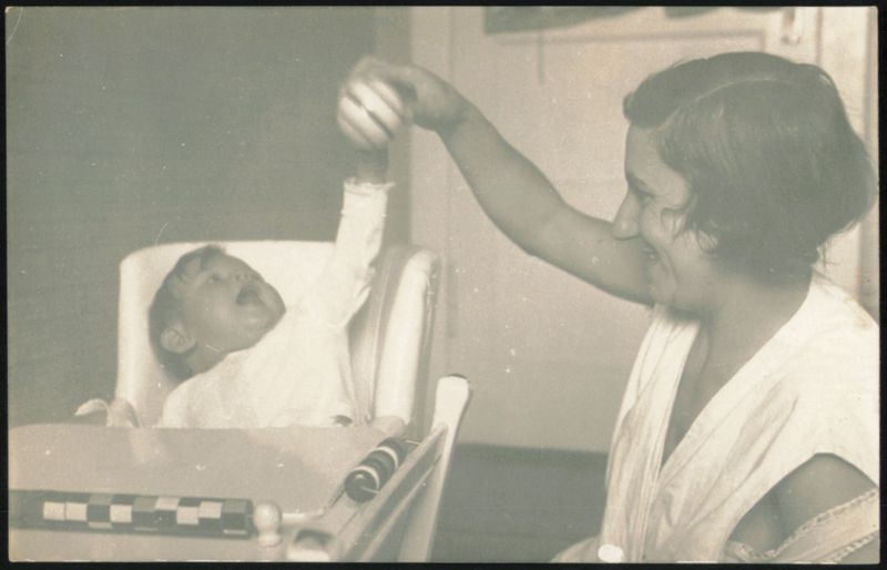 Mother and Baby Playing in High Chair Babies