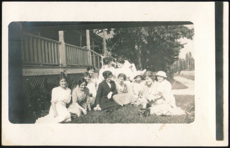 Eleven Women Gathered Outdoors on Lawn by House