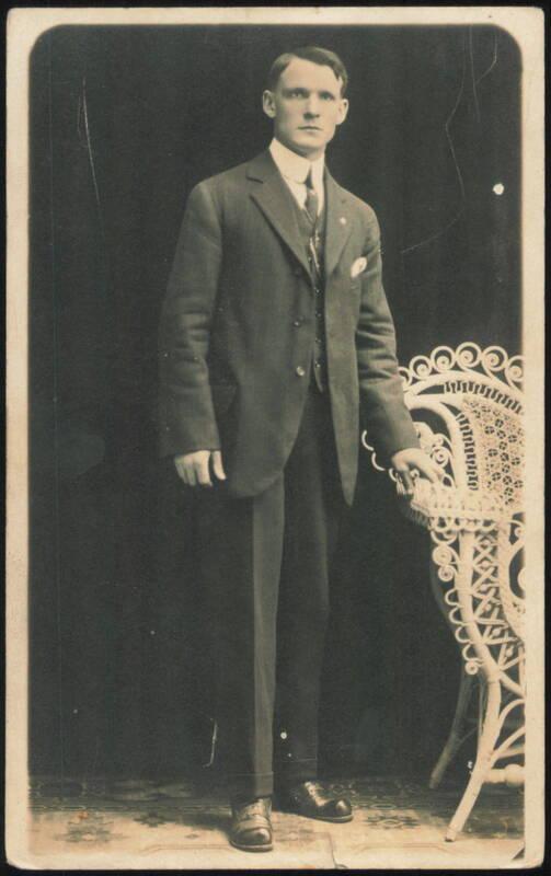 Young Man in Suit with Wicker Chair Portrait Men
