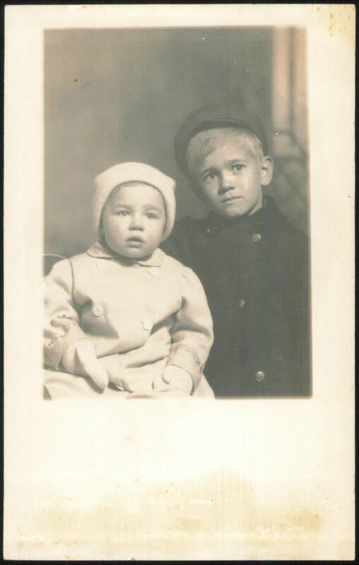 Two Children, Baby in Coat and Hat, Boy in Cap