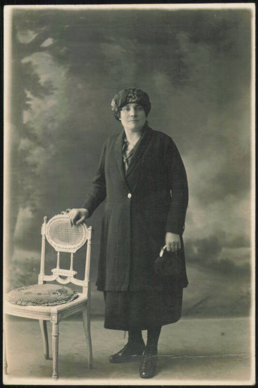 Woman in Coat and Hat with Ornate Chair Women