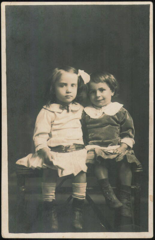 Two Young Girls Sitting Together Children
