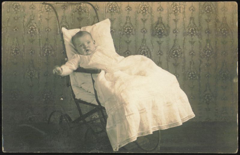 Baby in Long White Gown in Pram Babies